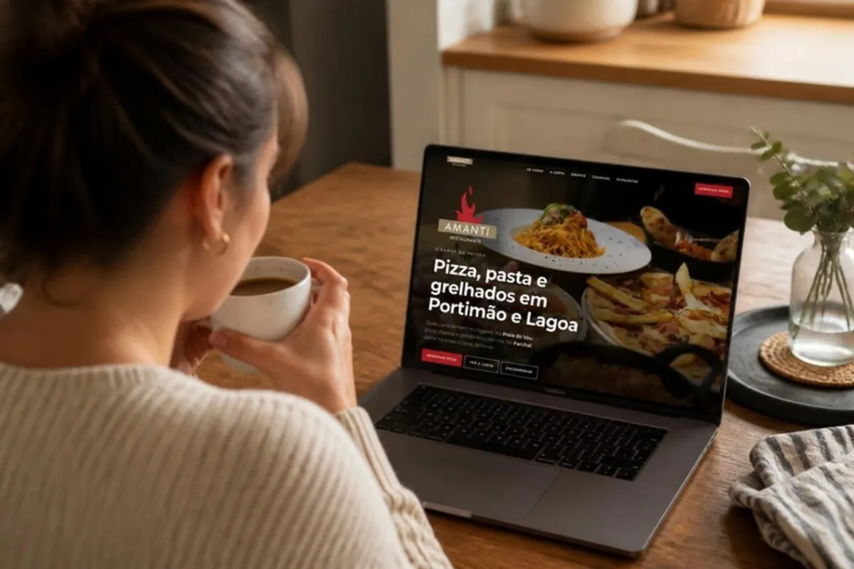 Cliente em casa, à mesa da cozinha, a ver o site do Amanti no portátil.